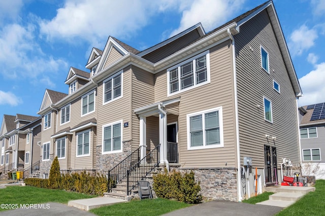 view of front of home featuring stone siding and a residential view