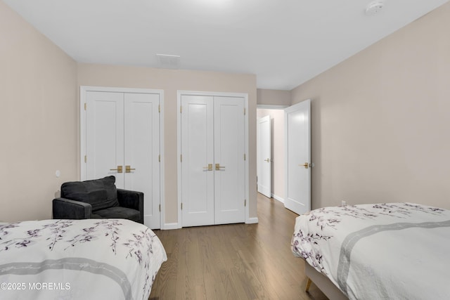 71 Broadway Ave, Lakewood, NJ 08701 - bedroom featuring baseboards, multiple closets, and wood finished floors