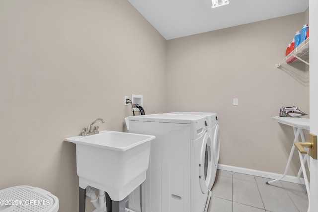 71 Broadway Ave, Lakewood, NJ 08701 - washroom featuring washing machine and dryer, light tile patterned floors, baseboards, a sink, and laundry area