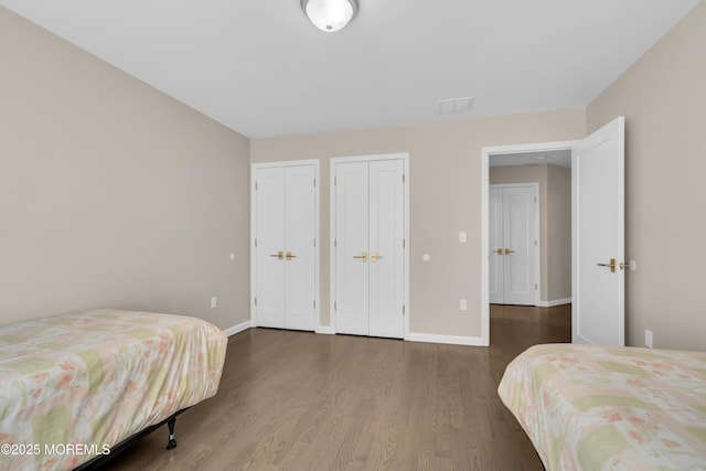 71 Broadway Ave, Lakewood, NJ 08701 - bedroom with two closets, baseboards, and wood finished floors