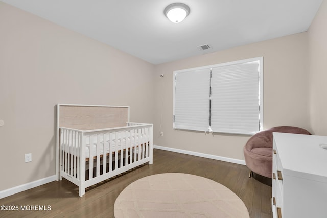71 Broadway Ave, Lakewood, NJ 08701 - bedroom with a crib, baseboards, visible vents, and wood finished floors