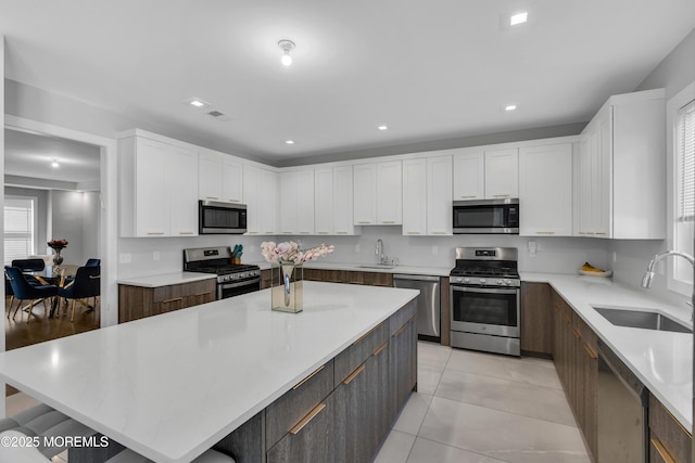 71 Broadway Ave, Lakewood, NJ 08701 - kitchen with a sink, white cabinetry, and appliances with stainless steel finishes