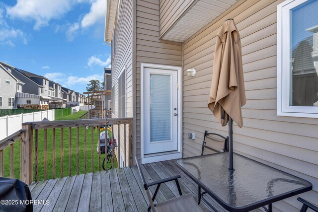 71 Broadway Ave, Lakewood, NJ 08701 - doorway to property with a residential view, fence, a wooden deck, a lawn, and outdoor dining area