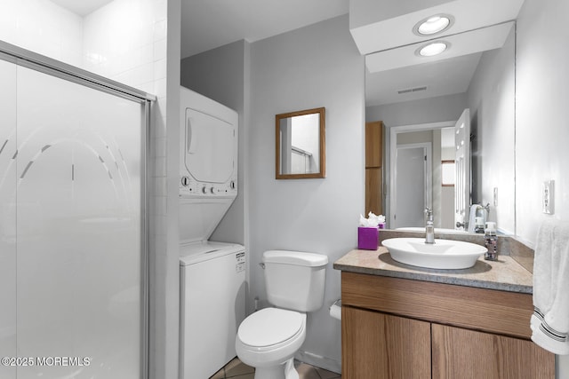 full bathroom with stacked washer / dryer, a shower stall, visible vents, toilet, and vanity