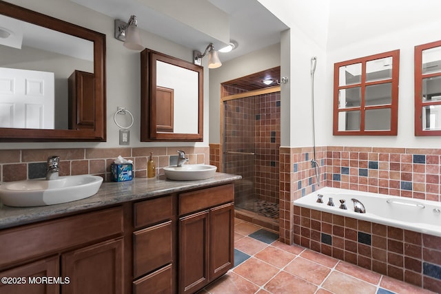 full bathroom with tile patterned flooring, a shower stall, and a sink