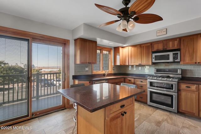 kitchen with brown cabinetry, a ceiling fan, tasteful backsplash, and stainless steel appliances