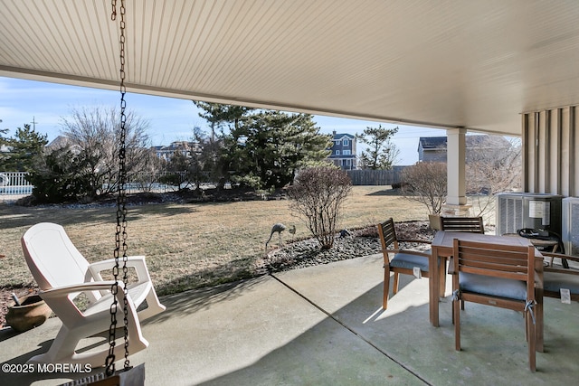 view of patio / terrace with outdoor dining space, central AC unit, and fence