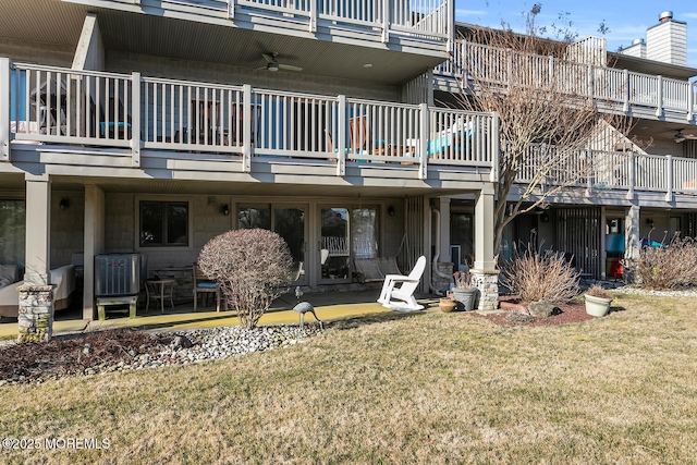 back of house featuring a patio area, ceiling fan, cooling unit, and a yard