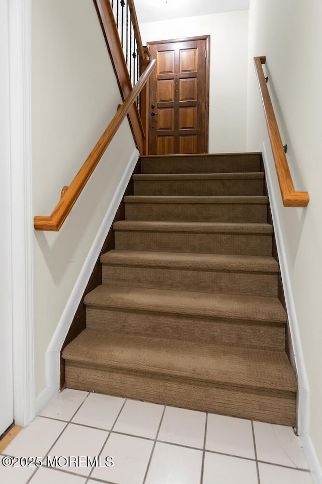 stairway featuring tile patterned flooring