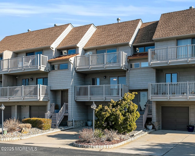 view of building exterior featuring an attached garage and driveway