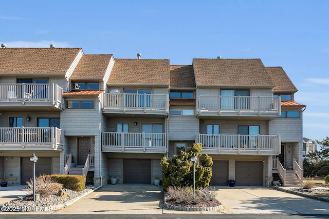 view of property with an attached garage and driveway