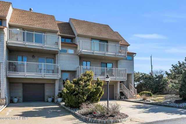 view of building exterior featuring concrete driveway and a garage