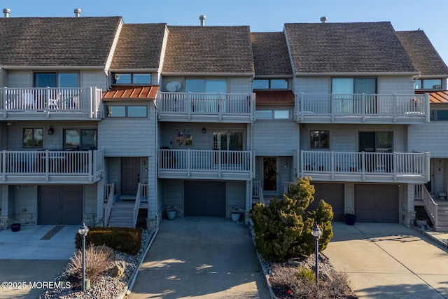 view of building exterior featuring a garage and driveway