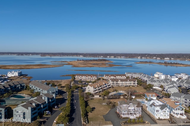 drone / aerial view with a residential view and a water view