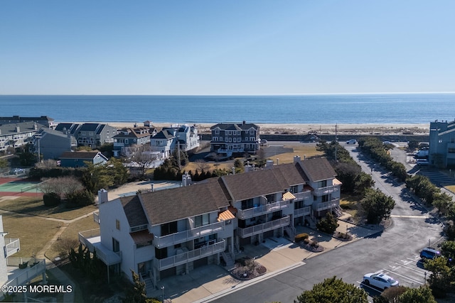 bird's eye view with a water view and a beach view