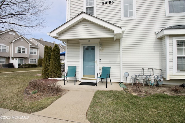 entrance to property featuring a lawn