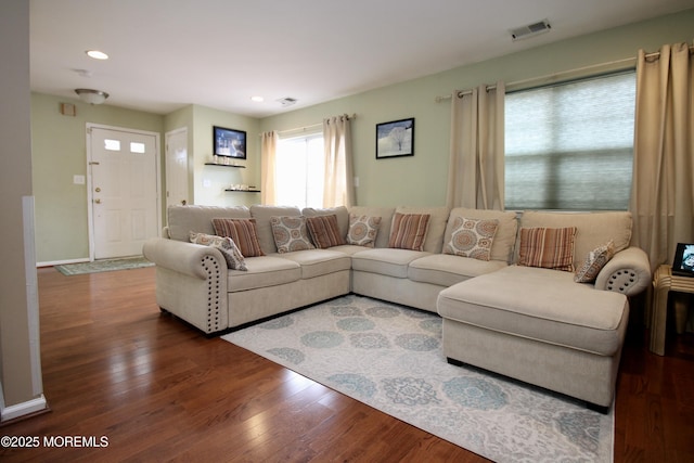 living room featuring recessed lighting, wood finished floors, visible vents, and baseboards