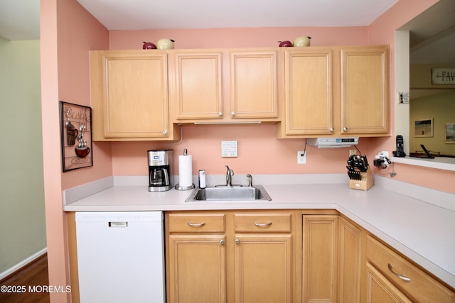 kitchen with light brown cabinetry, a sink, light countertops, and white dishwasher