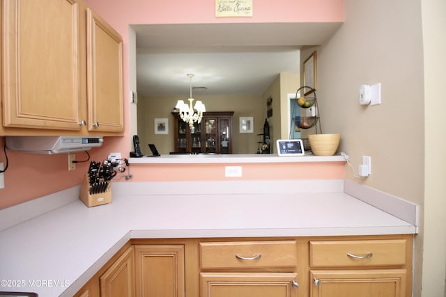 kitchen with a notable chandelier and light countertops