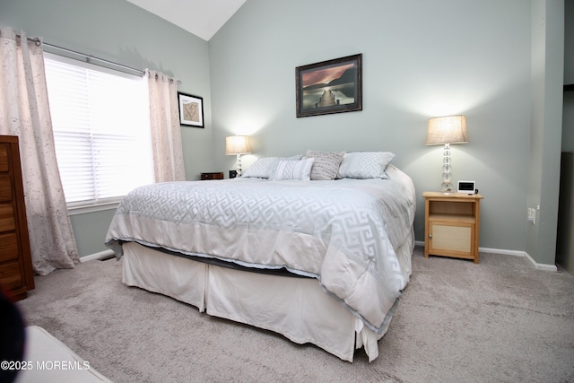 carpeted bedroom featuring vaulted ceiling and baseboards