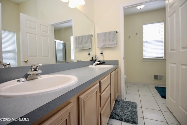 full bathroom with a sink, visible vents, a stall shower, and tile patterned flooring