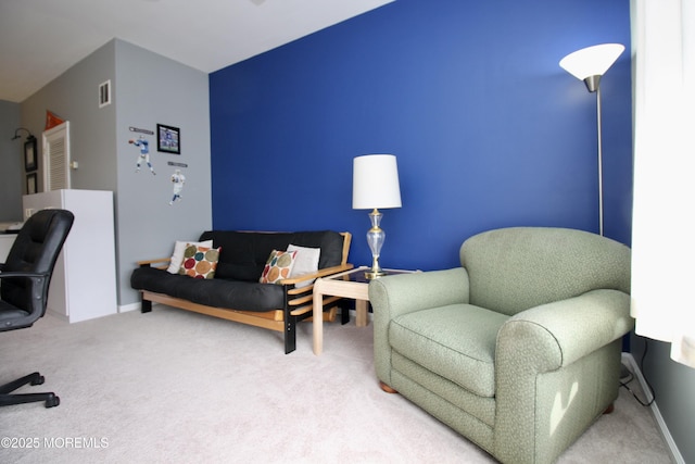 carpeted office space with baseboards and visible vents