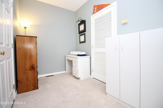 unfurnished bedroom featuring visible vents, light carpet, and baseboards