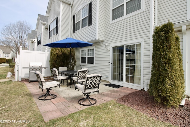 view of patio with a grill and fence