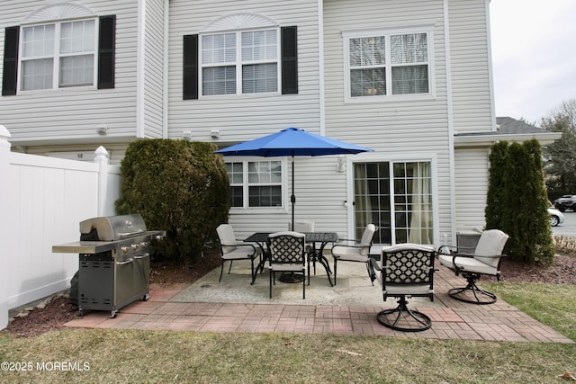 view of patio featuring area for grilling and fence