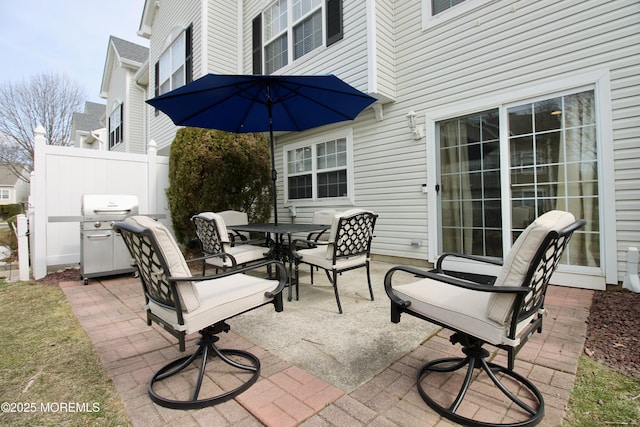 view of patio / terrace featuring outdoor dining space, fence, and grilling area