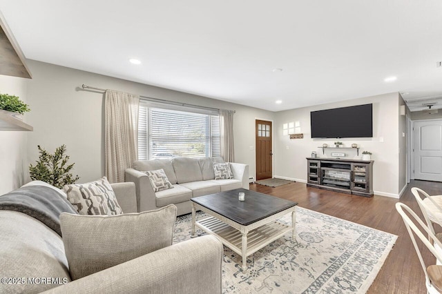 living room featuring recessed lighting, baseboards, and wood finished floors