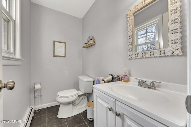 bathroom with baseboards, toilet, tile patterned floors, vanity, and a baseboard radiator