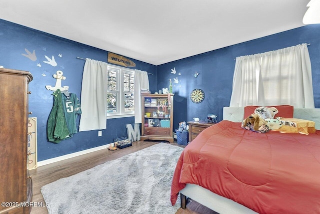 bedroom featuring baseboards and wood finished floors