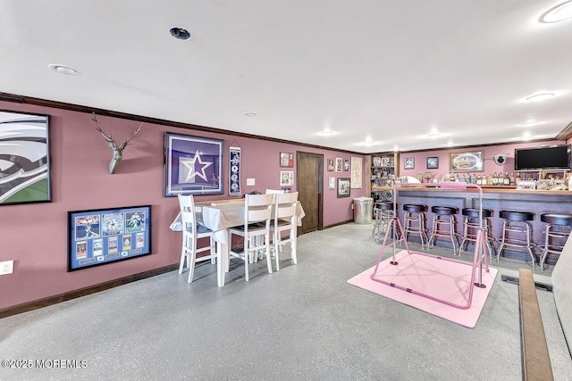 playroom with baseboards, a dry bar, and crown molding