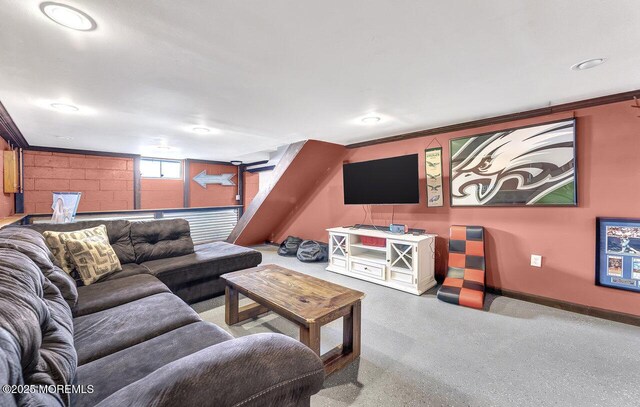 living room featuring concrete block wall and baseboards