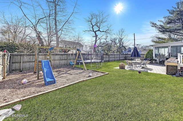 view of yard featuring a playground, a trampoline, a patio area, and a fenced backyard