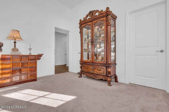 interior space featuring carpet flooring and baseboards