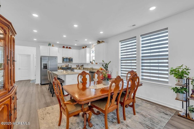 dining room featuring visible vents, recessed lighting, light wood-type flooring, and baseboards