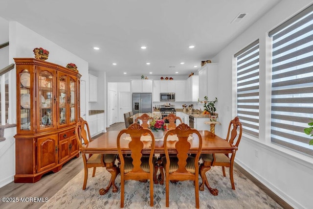 dining area with recessed lighting, visible vents, baseboards, and light wood finished floors