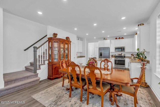 dining area featuring stairway, recessed lighting, baseboards, and light wood finished floors
