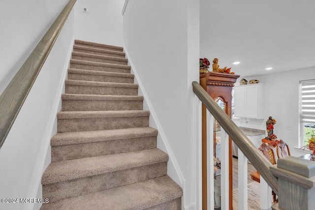 staircase featuring recessed lighting