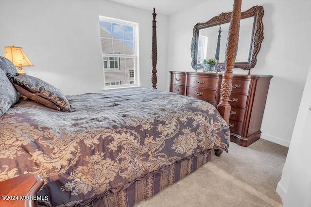 carpeted bedroom featuring baseboards