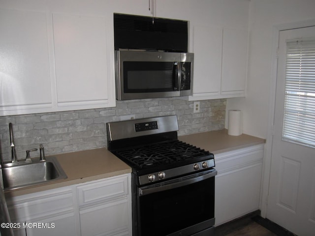 kitchen featuring white cabinetry, light countertops, and appliances with stainless steel finishes