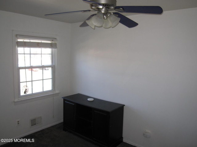 unfurnished room with visible vents, baseboards, and ceiling fan