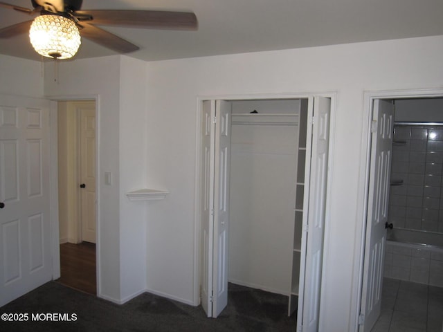 unfurnished bedroom featuring a closet, baseboards, ceiling fan, and ensuite bathroom