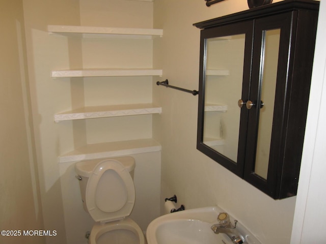 bathroom featuring toilet and a sink