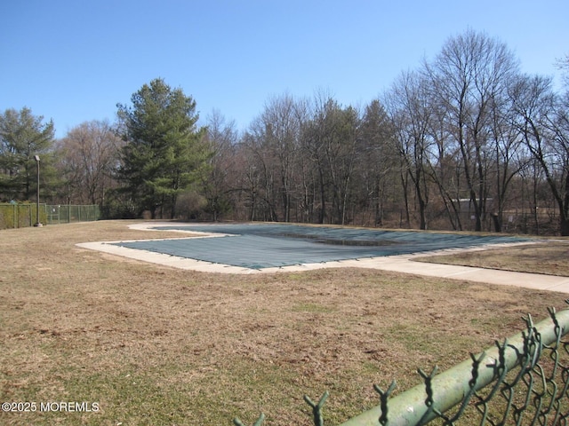 exterior space with a hot tub and fence