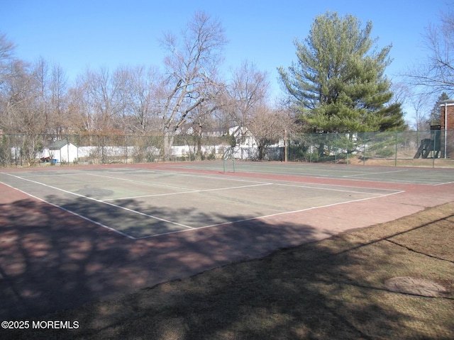 view of sport court featuring fence