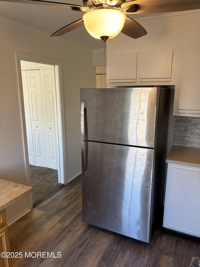 kitchen featuring ceiling fan, white cabinetry, dark wood-style floors, and freestanding refrigerator