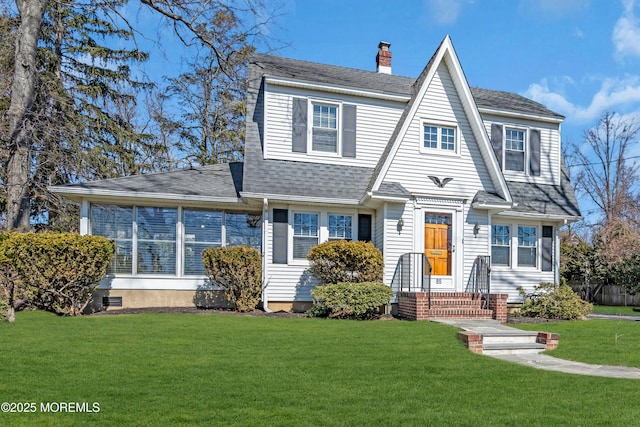 view of front of home with a chimney, a front yard, and a shingled roof